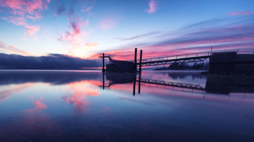 photo of view of Pier with diving tower during sunset located in Hamar, Norway.