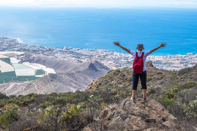 Hiker in the mountains of Arona and view of the coast, Tenerife, Canary Islands