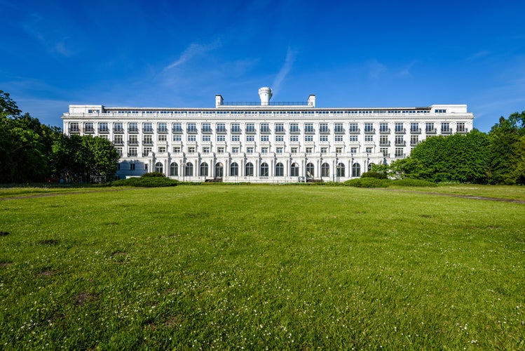 The historical hotel Kemeri (later sanatorium) after restoration of the building and park. In front of the facade of the white building, a walking square with white roses. Latvia. Jurmala. Kemeri.