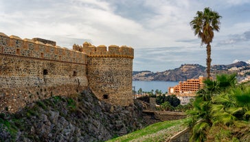 photo of Almuñécar, Spain - A scenic view of a coastal city with white buildings and a blue ocean in the background.