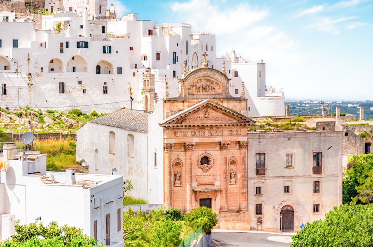 Photo of Ostuni white town skyline with Church of San Francesco, southern Italy.