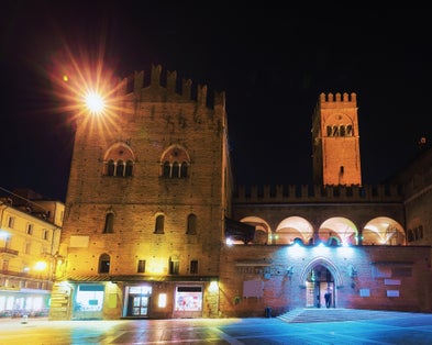 PHOTO OF People at Palazzo Re Enzo on Piazza del Nettuno Square in Bologna, Emilia-Romagna, Italy. Late in the evening