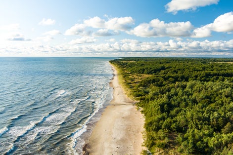 Aerial view of the Baltic Sea shore line near Klaipeda city, Lithuania. Beautiful sea coast on sunny summer day.