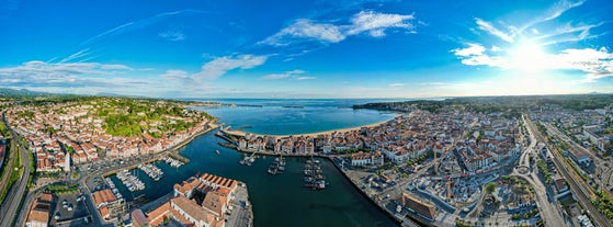 Photo of cityscape of French border town Hendaye, as seen from Spanish Hondarribia, with Famous Rhune Mount at Background, France.