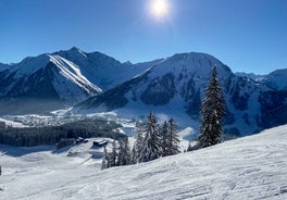 Photo of a view of the Alps from the Ehrwald, a town on the border of Germany and Austria with picturesque meadows surrounded by towering mountain ranges, including the Zugspitze.