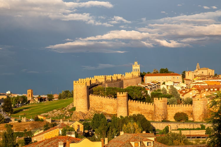 photo of view of Sunset with cloudy sky over the medieval walled city, Avila, Spain.