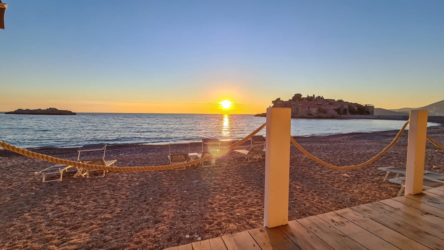 Photo of scenic sunset view from beach bar in Sveti Stefan, Montenegro.