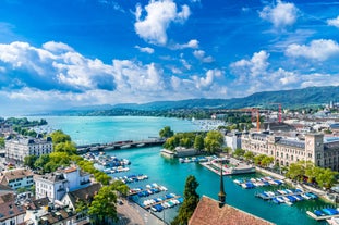 Panoramic view of historic Zurich city center with famous Fraumunster, Grossmunster and St. Peter and river Limmat at Lake Zurich on a sunny day with clouds in summer, Canton of Zurich, Switzerland